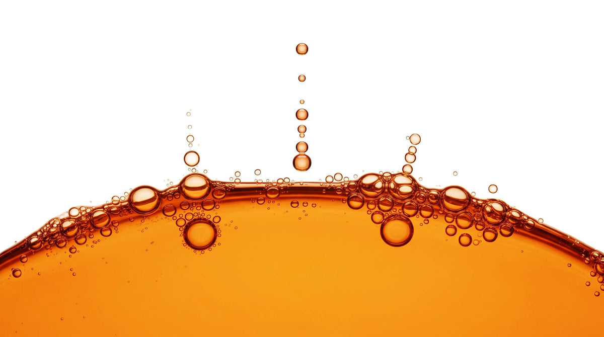Rising orange liquid droplets, an Inspire liquid-format wellness visual for the USA